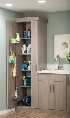 the bathroom is clean and ready to be used as a storage unit for cleaning supplies