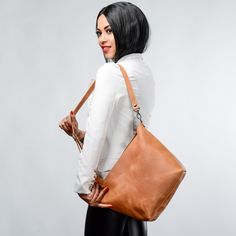 Comfortable and popular leather bag. It is made of full grain leather caramel color. Great for daily use. Ideal for work, study. The bag has internal pocket, so it is very roomy and functional (for a phone, book, keys, tablet, cosmetic bag, etc.). Can be use as woman laptop bag. The bag has an adjustable shoulder strap that allows you to carry the bag both on the shoulder and in the hand. This bag can be a wonderful gift for birthday. Handmade leather bag! ● Unique leather over time gets better. Cognac Leather Hobo Bag For Everyday Use, Everyday Light Brown Satchel Shoulder Bag, Everyday Cognac Leather Hobo Bag, Cognac Hobo Bag For Travel, Elegant Brown Leather Backpack For Everyday, Trendy Cognac Leather Shoulder Bag, Leather Shoulder Bag For On-the-go, Minimalist Brown Hobo Bag For Travel, Daily Use Shoulder Bag With Smooth Grain