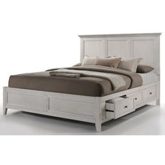 a white bed with drawers underneath it