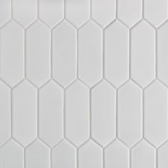 a white tiled wall with hexagonal shapes