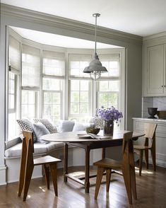 a living room filled with furniture and windows