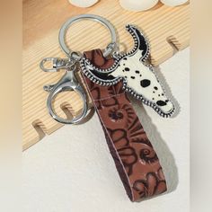 a key chain with a cow's head on it