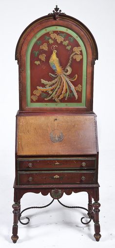 an old wooden desk with a painted peacock on it