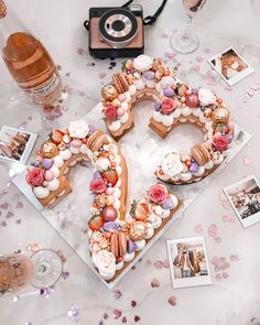 a cake shaped like the number 50 with flowers and hearts on it sitting on a table