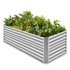 a large metal garden box filled with lots of green plants and flowers on an isolated white background