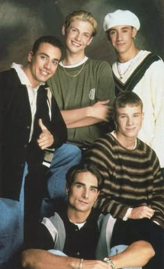 four young men are posing for a photo