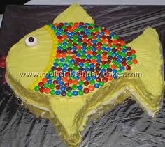 a yellow fish cake with lots of candy on it