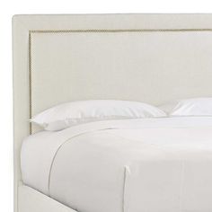 the headboard is made up with white linen