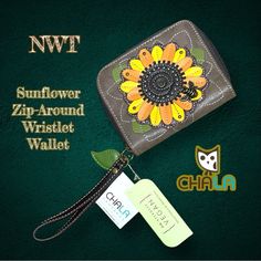 a small wallet with a flower on it and a tag attached to the front of it