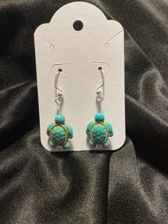 these earrings are made with either silver or gold wire, and turquoise turtle charms. Handmade Turtle-shaped Sterling Silver Jewelry, Stretchy Beaded Bracelet, Diy Jewelry Unique, Turtle Charm, Turtle Earrings, Earrings Turquoise, Dangly Earrings, Gold Wire, Jewelry Unique