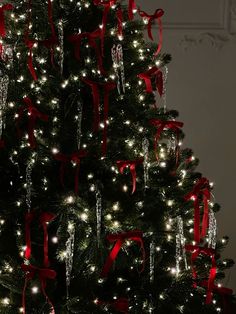 a decorated christmas tree with red bows and lights