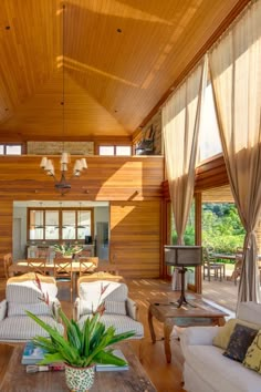 a living room filled with furniture and wooden walls