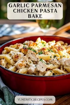 garlic parmesan chicken pasta bake in a red bowl on a wooden table