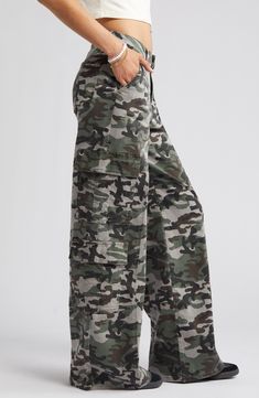 Give in to your style nostalgia and throw it back to Y2K in a pair of wide-leg cargo pants cut from a stretchy cotton blend patterned with classic camo. 32" inseam; 25 1/2" leg opening; 10" front rise; 15" back rise 97% cotton, 3% spandex Machine wash, tumble dry Imported Baggy Camo Pants, Military Camouflage Wide Leg Cargo Jeans, Camouflage Wide-leg Bottoms With Multiple Pockets, Cheap Full-length Camouflage Cargo Pants, Military-style Camouflage Cargo Jeans With Side Pockets, Camouflage Military Cargo Pants, Camouflage Jeans, Wide Leg Cargo Pants, Throw It Back