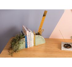 a wooden table topped with books and a plant