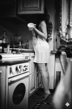 a woman standing in a kitchen holding a bowl