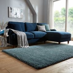 a living room with a blue couch and rug