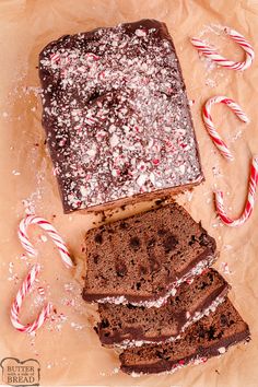 chocolate cake and candy canes on top of brown paper with white sugar sprinkles