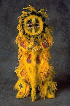 a yellow lion costume sitting in front of a gray background