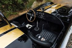 the interior of a black and gold sports car