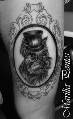 a black and white photo of a man's leg with an owl wearing a top hat