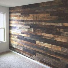 an empty room with wood paneling on the wall