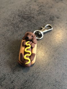 a hot dog keychain that is shaped like a dog