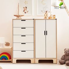 a child's room with two white cupboards and a teddy bear on the floor