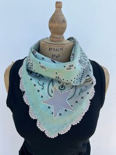 Looking for a unique accessory? This one of a kind  bandana is embellished with a painted star outlined in crystal bling with a lace embellished edge.  This is the perfect accessory to top off your outfit.  This embellished bandana has been tea stained and tattered slightly to give it a soft vintage vibe.  Have fun with it as it is the perfect accessory to most any boho, cowgirl chic or festival outfit.  All fabrics are sanitized before assembly. Thank you for visiting my site Handmade Adjustable Cotton Bandana, Adjustable Handmade Cotton Bandana, One Size Cotton Bandana For Festival, Cotton Bandana For Festivals, Handmade Cotton Summer Bandana, One Size Fits Most Cotton Bandana For Festival, Handmade Cotton Bandana For Summer, Blue Bohemian Bandana For Summer, Hippie Cotton Bandana For Festivals