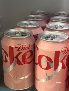 several cans of diet coke are stacked on top of each other