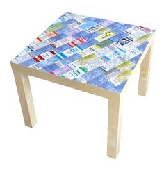 an image of a table made out of magazines and newspaper pages with text underneath it