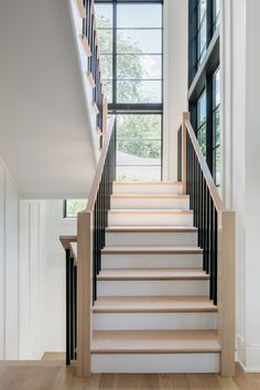 the stairs are made of wood and have black railings