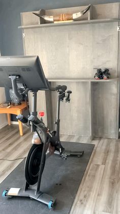 there is a bike and computer on the floor