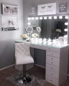 a white chair sits in front of a vanity with lights on it and a mirror