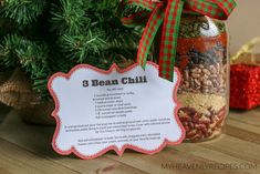 a mason jar filled with beans next to a christmas ornament on top of a wooden table