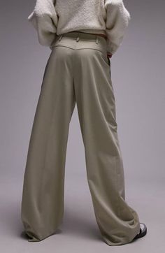 "Find TOPSHOP Pleated High Waist Wide Leg Trousers on Editorialist. An exaggerated silhouette lends a modern, fashion-forward feel to pleated, floor-sweeping wide-leg pants made from trouser-style stretch fabric. 31\" inseam; 24\" leg opening; 13\" front rise; 16\" back rise (size 8) Zip fly with hook-and-bar closure Front slant pockets 70% polyester, 22% viscose, 4% wool, 4% elastane Machine wash, line dry Imported" Chic Pleated Wide-leg Bottoms, Beige Pleated High-waist Bottoms, Luxury Wide-leg Bottoms With Pleated Waist, Beige Pleated Full-length Bottoms, Brown Pleated Wide-leg Bottoms, Korean Pants, Trouser Style, Wide Leg Trousers, Top Brands