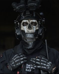 a man in skeleton makeup holding a baseball bat and wearing a helmet with skulls on it