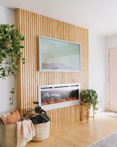 a living room filled with furniture and a fire place next to a wall mounted tv