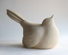 a white ceramic bird sitting on top of a table