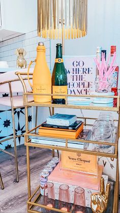 a gold bar cart with bottles and glasses on it