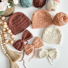 crocheted hats and accessories laid out on a table