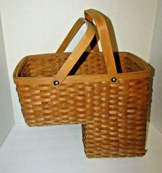 two wicker baskets sitting next to each other on a white floor in front of a wall