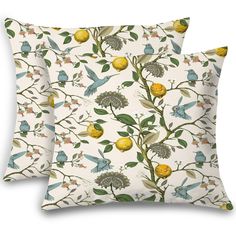 two pillows with birds and lemons on them, one is yellow and the other is white