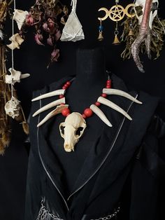 Have a Look at This Beautiful Gothic Red Racoon Skull Necklace! This Necklace Has 6 Real Deer antler Points! The Skull itself is In Almost Perfect Condition. It is Strung on Black Leather And Beads With Red Wood Beads. This Necklace is Adjustable From 22 - 27 Inches. All Items Ship Within 1-3 Days via USPS Ground Advantage Service. Shipping on these will be 5.50 (USA Only) All additional items are FREE! I Am Only Offering International Shipping To Canada Right Now, I Apologize as Customs Overseas is Growing Evermore Difficult With Bones and Skulls. Canada 25.00 + 2.00 For Each Additional Item. I DO NOT Carry Human Bones or Any Sort of Illegal Items. And As Etsy Sellers, We Are Not Allowed to Sell Domesticated Dog or Cat Bones of Any Sort. All The Bones Here are Legal to Buy, Sell, And Own Doctor Voodoo, Voodoo Costume, Dark Devil, Raccoon Skull, Real Skull, Red Gothic, Antler Necklace, Human Bones, Witch Doctor