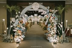 an entrance to a building decorated with flowers and greenery for a wedding or reception