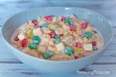 a white bowl filled with cereal on top of a wooden table