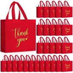 red bags with gold foil lettering and thank you written on the front are lined up against a white background