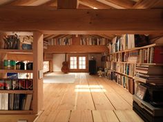 a room filled with lots of books on top of wooden shelves next to a doorway