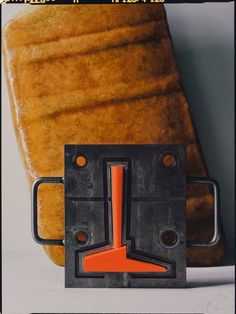 a piece of bread sitting on top of a table with an orange arrow in the middle