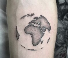 a black and white photo of the world on someone's arm